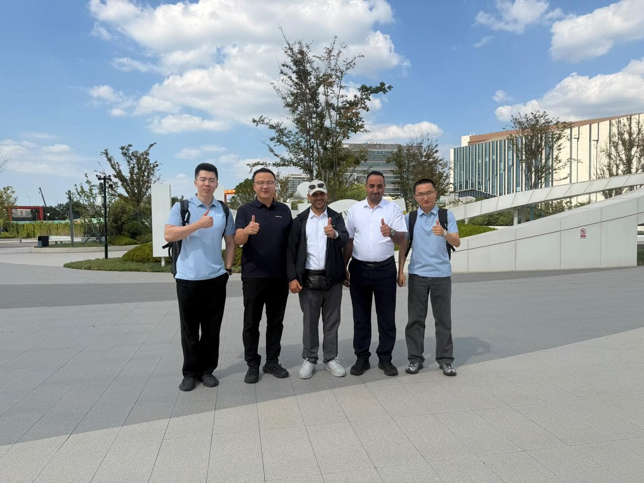 O&G Trading Services delegation and Haier representatives outside the corporate campus